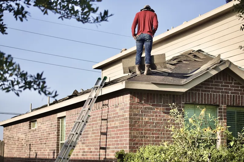 Professional roofer working on a residential roof in Bucktoe